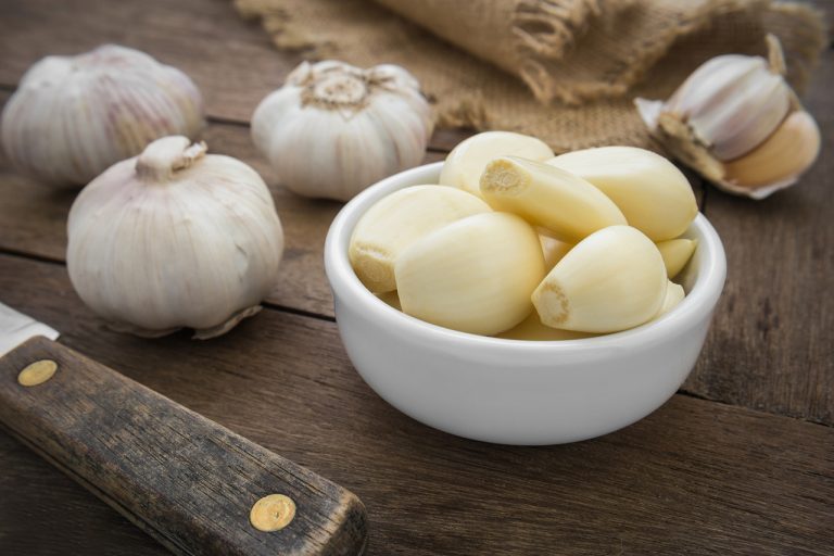 Peeled garlic in bowl Rising Tide Natural Market